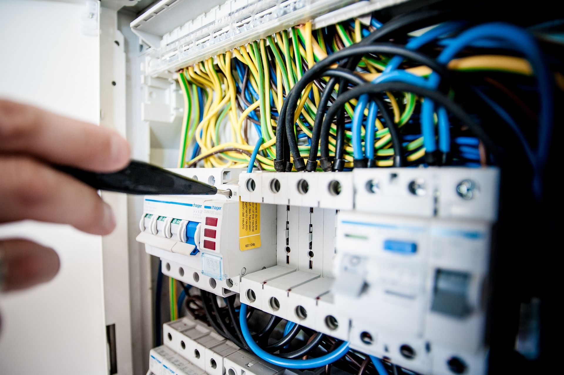 Electrical Systems - Technician inspecting an electrical distribution panel