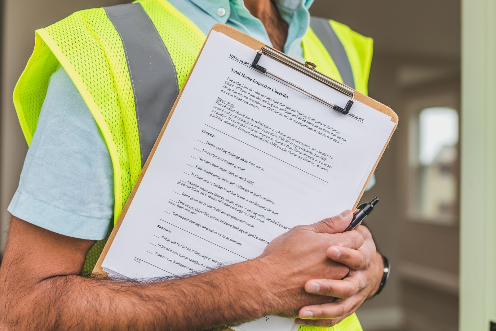 Inspector holding a technical inspection checklist and report
